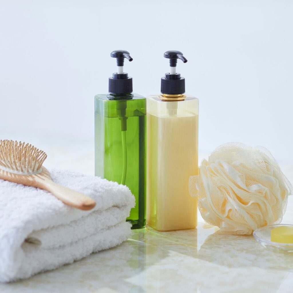 Neat arrangement of essential bath and hygiene items, like body wash and shampoo, representing donations for Operation HOPE families.