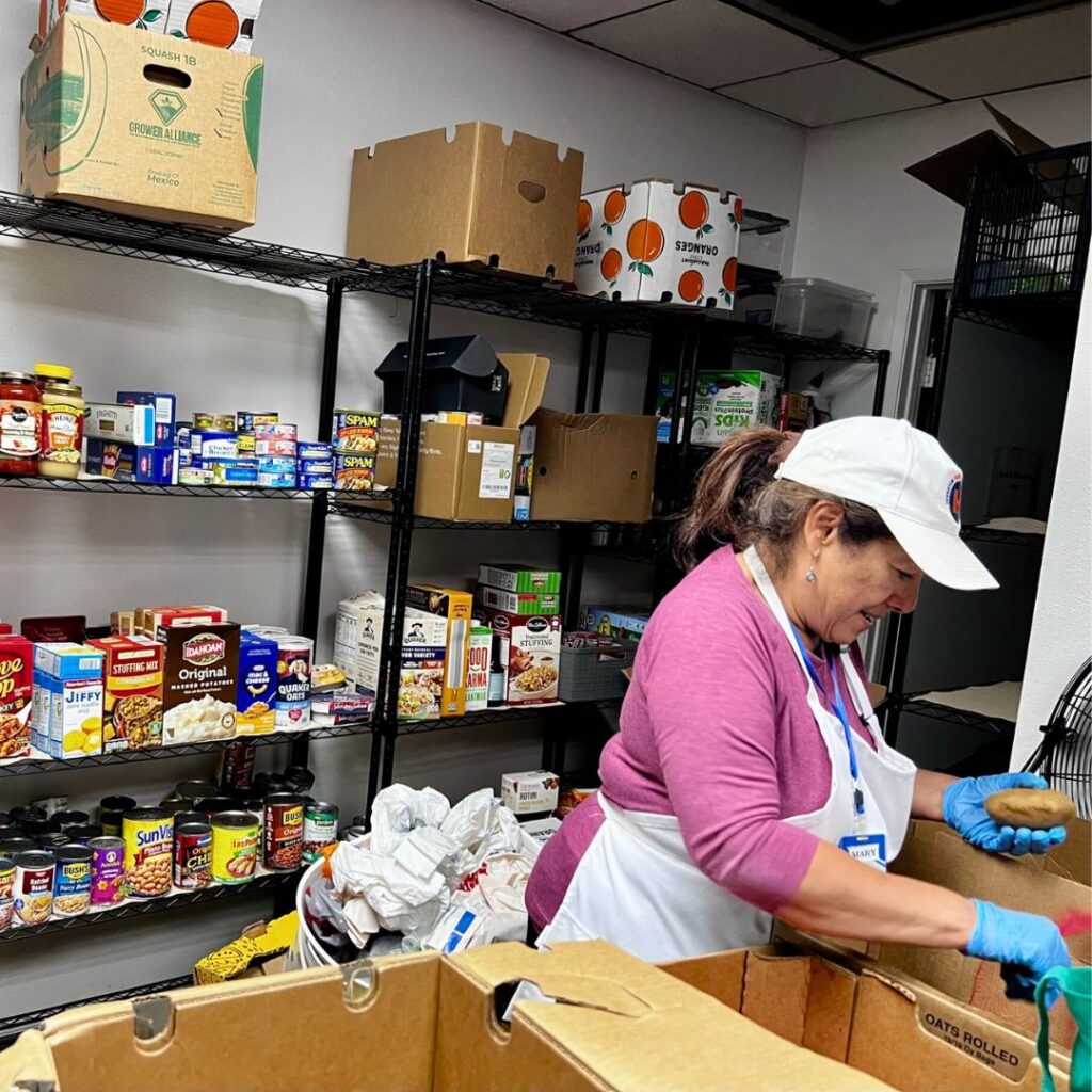 A volunteer in the Pantry of Hope sorting produce to support the community.